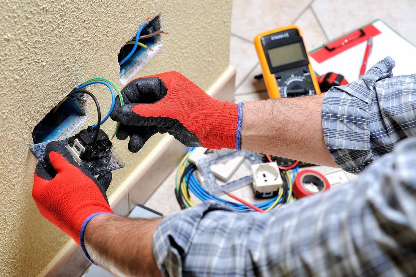 Electrician rewiring a socket outlet